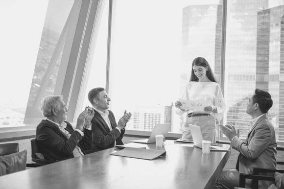 Employees working together at a business with a strong company culture.