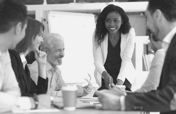 Management consultants work in an office. You can use this management consultant job description to grow your team.