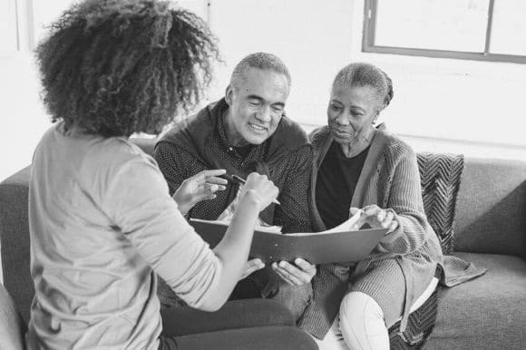 Patient advocate educating her clients on the details of their medical coverage.