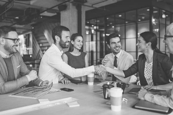 Office-full of workers, greeting a newly recruited member of the team.