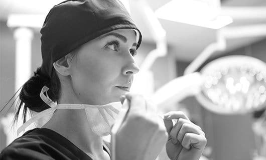 healthcare worker putting on surgical mask