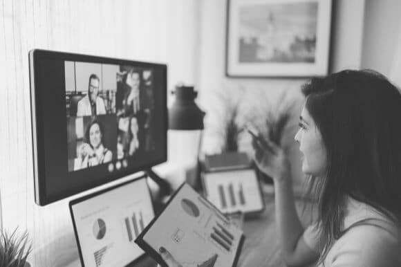 Manager using remote work tips on conference call with employees