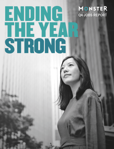 A woman standing in a city looks optimistically upward